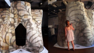 A Berkley student stands beside the concrete structure in amazement