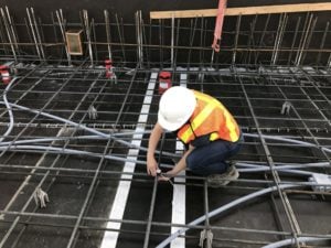 worker installing a concrete sensor