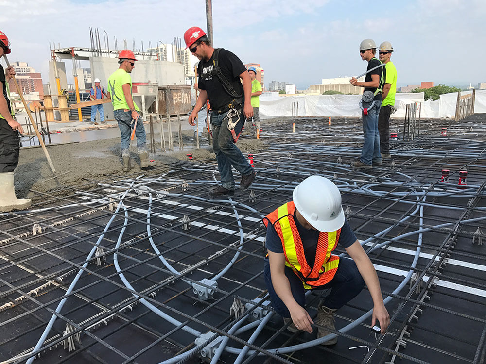 Construction worker installing concrete temperature logger at jobsite