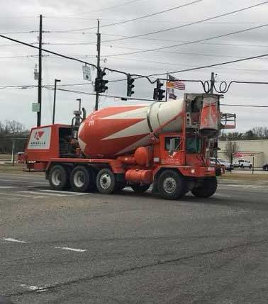 Orange and White Ready-Mix Concrete Truck on Road