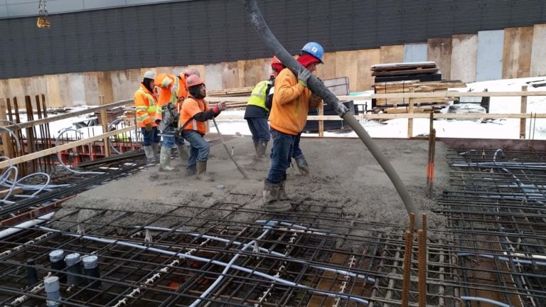 Workers placing concrete in cold weather
