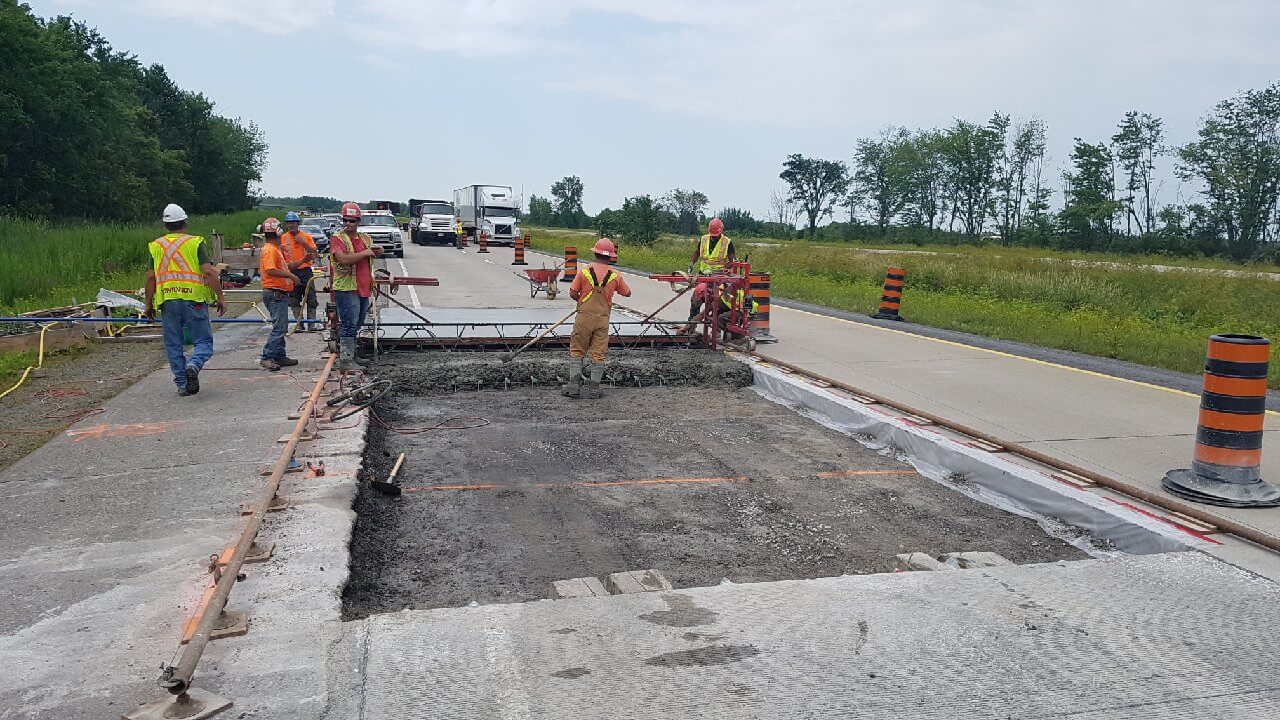 Placing concrete on highway construction project