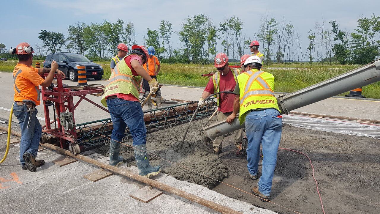 Placing concrete on highway construction project