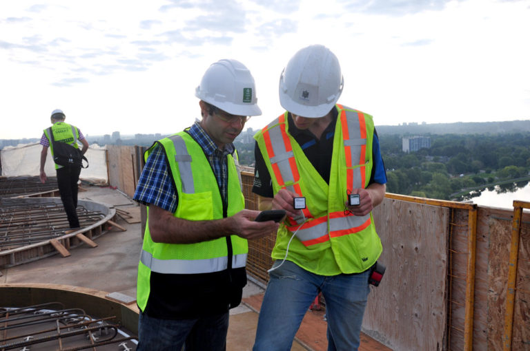 Engineers looking at sensor data on construction site