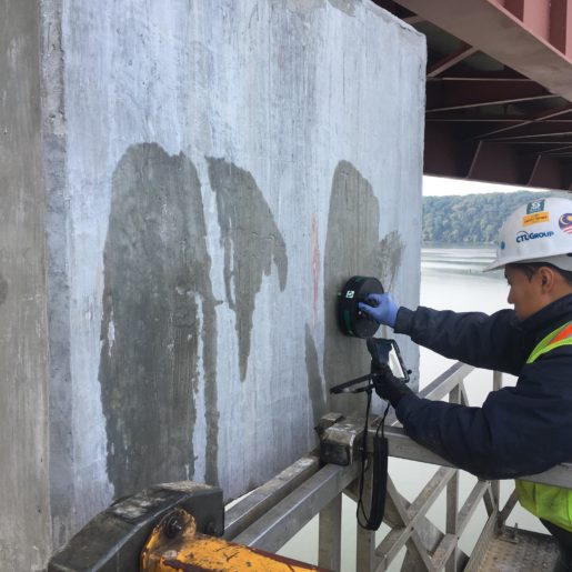 Construction worker using Giatec iCOR on a bridge