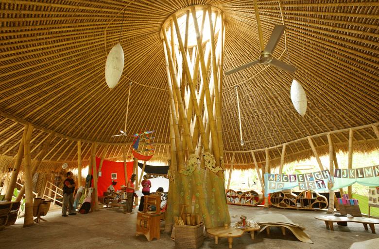 The bamboo nursery classroom with bent beams and a radial roof system, designed for young learners in a naturally lit and breathable structure.