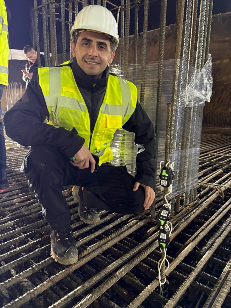 Worker Posing with SmartRock on Two Towers Project
