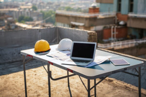 Concept of architects, engineer equipments on the desk with a blueprint in construction site.